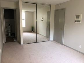 San Diego apartment for rent - the master bedroom has a large mirror and a carpeted floor