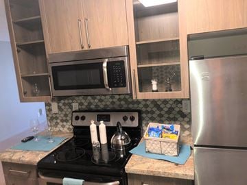 San Diego apartment for rent - a kitchen with stainless steel appliances and wooden cabinets
