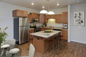 Bismarck apartment for rent - A modern kitchen with wooden cabinets and stainless steel appliances.