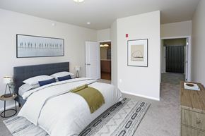 Bismarck apartment for rent - A bedroom with a large bed and a painting on the wall.