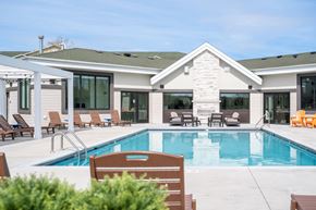 Rochester apartment for rent - A house with a pool in the backyard.