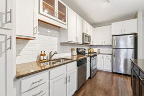 Eden Prairie apartment for rent - A kitchen with white cabinets and a granite counter top.