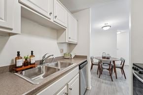 Woodbury apartment for rent - Kitchen with sink and dining room at The Bosk Apartment Homes, Woodbury, MN, 55125