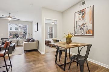 Denver apartment for rent - A living room with a dining table and chairs.