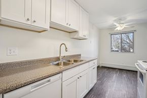 Eagan apartment for rent - A kitchen with white cabinets and a granite countertop.