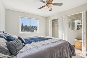 Burnsville apartment for rent - A bedroom with a large bed and a ceiling fan.