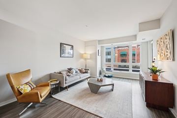 St. Paul townhouse for rent - A living room with a brown leather chair and a grey sofa.