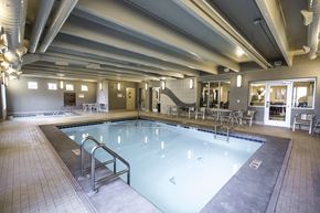 Bismarck apartment for rent - A large indoor swimming pool with a metal ladder.