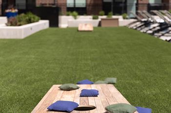 Pool terrace with lawn games and lounge areas