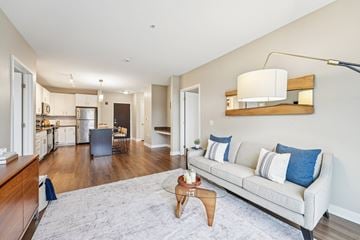 Eden Prairie apartment for rent - A living room with a grey couch and a wooden coffee table.