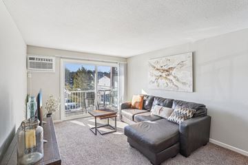Burnsville apartment for rent - A living room with a grey couch and a painting on the wall.