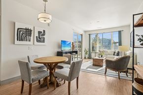 Longmont apartment for rent - A modern dining room with a round wooden table and grey chairs.