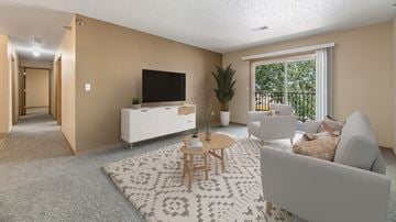 Rapid City apartment for rent - a living room with a white rug and a couch and a television