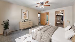 Rapid City apartment for rent - a bedroom with a large bed and a ceiling fan