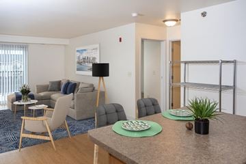 Grand Forks apartment for rent - a living room and dining room with a table and chairs and a couch