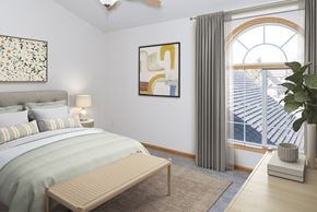 Rochester townhouse for rent - a bedroom with a large window and a bench at the end of the bed