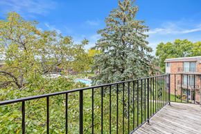New Hope apartment for rent - A balcony with a black railing overlooks a pool and trees.