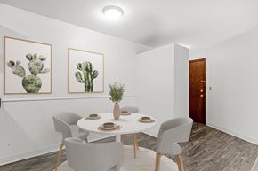 New Hope apartment for rent - A dining room with a table set for two and two cactus pictures on the wall.