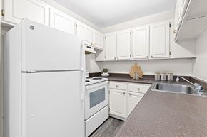 New Hope apartment for rent - A white refrigerator is in a kitchen with white cabinets.