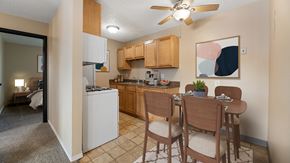 Rapid City apartment for rent - an open kitchen and dining area with a dining table and chairs