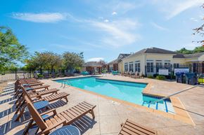 Rochester townhouse for rent - A sunny day at the pool with lounge chairs and a clear blue sky.