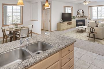 Rochester townhouse for rent - a kitchen with a sink and a living room with a tv