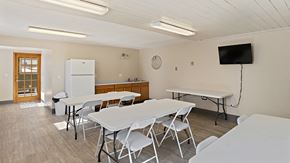 Billings apartment for rent - a dining room with tables and chairs and a television