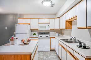 Billings apartment for rent - a kitchen with white appliances and wooden cabinets