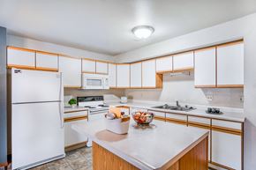 Billings apartment for rent - a kitchen with white appliances and wooden cabinets