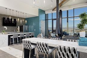 Denver apartment for rent - Sky lounge kitchen area, with full kitchen and bar, high seating, and fireplace connected to the ceiling
