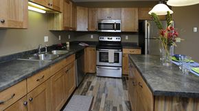 Bismarck apartment for rent - a kitchen with wooden cabinets and stainless steel appliances
