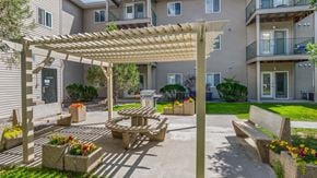 Billings apartment for rent - a patio with a picnic table and a pergola in front of a building
