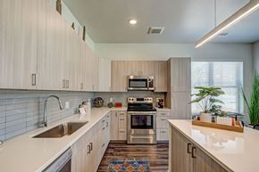Loveland apartment for rent - A modern kitchen with cabinets, white countertops and kitchen island.