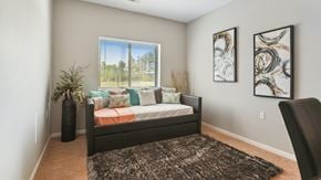 Jamestown apartment for rent - A bedroom with a bed, pillows, a carpet, and two pieces of artwork on the wall.
