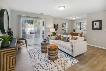 Lincoln apartment for rent - an open living room with a white couch and a rug