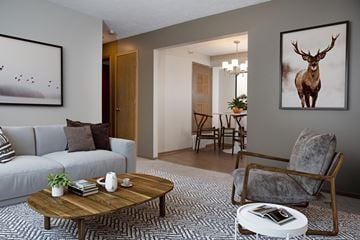 Omaha apartment for rent - a living room with a couch and a deer painting on the wall