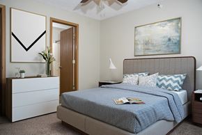 Omaha apartment for rent - Bedroom with Bed and Dresser and Attached Bathroom
