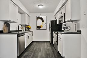 Omaha apartment for rent - Kitchen with Appliances, White Cabinets and Dark Hard Wood Flooring