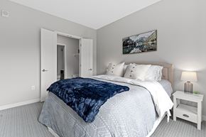 New Hope apartment for rent - A bedroom with a large bed and a painting on the wall.