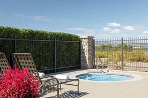 Loveland townhouse for rent - a jacuzzi and chairs on a patio next to a pool