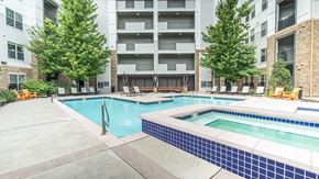 Denver apartment for rent - A large swimming pool surrounded by apartment buildings.