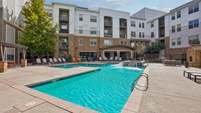 Denver apartment for rent - A large swimming pool in front of apartment buildings.