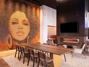 Denver apartment for rent - a conference room with a large painting of a woman on the wall