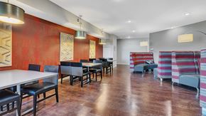 Monticello apartment for rent - a dining room with tables and chairs in front of a red wall