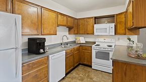 Billings apartment for rent - a kitchen with white appliances and wooden cabinets