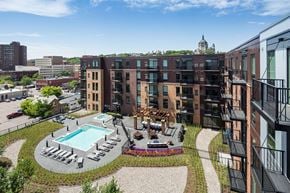 St. Paul townhouse for rent - Stunning panoramic view from the balcony at Oxbo Urban Rentals. Large pool deck, outdoor lounge area, and St Paul skyline can be seen from the balcony.