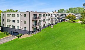 Roseville apartment for rent - Apartment complex with green grassy area in front.