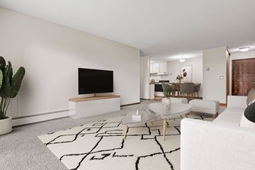 Plymouth apartment for rent - A modern living room with a white sofa and a black and white rug.