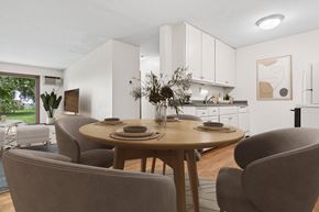 Plymouth apartment for rent - A modern dining room with a round table and grey chairs.