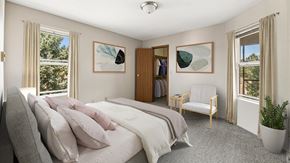 Rapid City apartment for rent - a bedroom with a bed and a chair and a closet